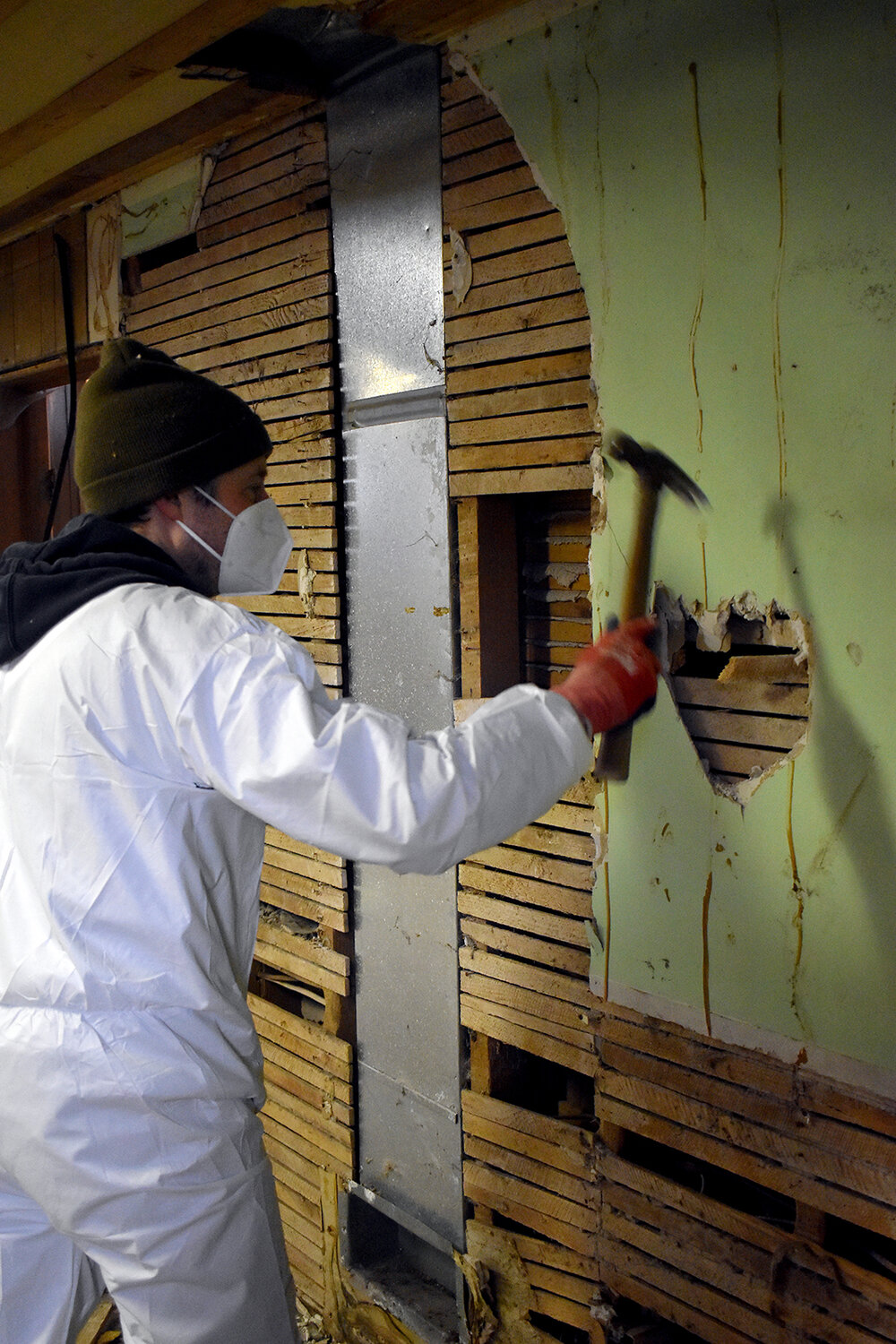 Victor Lipko cleans debris from a room in the church basement.
